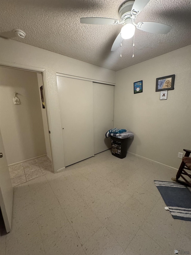 778 W Ramona St, Somerton, AZ 85350 - unfurnished bedroom with tile patterned floors, a textured ceiling, a ceiling fan, baseboards, and a closet