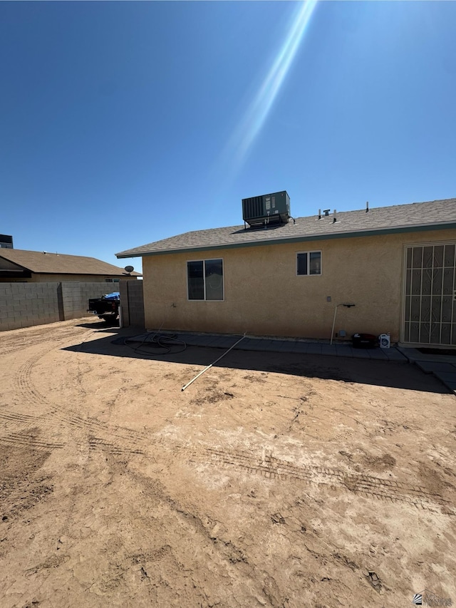 778 W Ramona St, Somerton, AZ 85350 - rear view of property featuring central AC, fence, and stucco siding