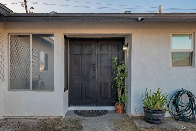 doorway to property with stucco siding
