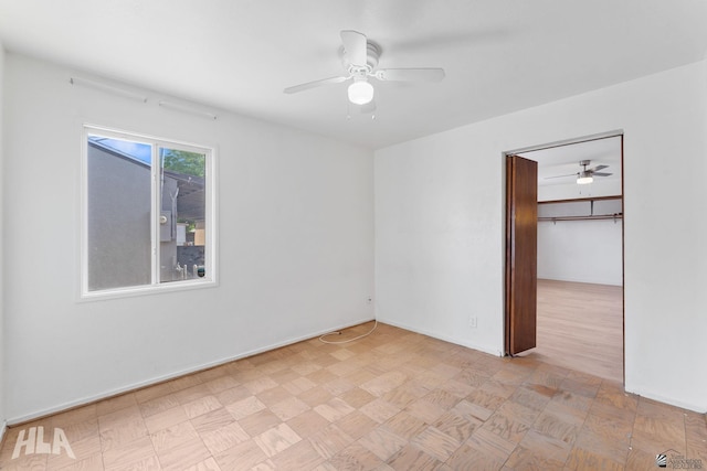 324 S 19th Ave, Yuma, AZ 85364 - unfurnished bedroom featuring a ceiling fan, a spacious closet, a closet, and baseboards