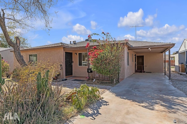 324 S 19th Ave, Yuma, AZ 85364 - ranch-style house featuring stucco siding, driveway, and an attached carport