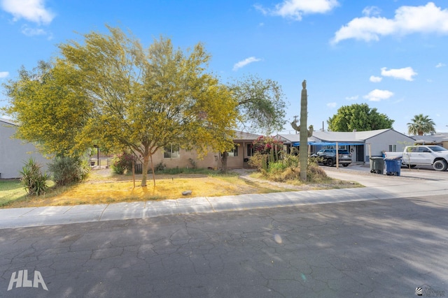 324 S 19th Ave, Yuma, AZ 85364 - view of front facade featuring concrete driveway, stucco siding, and a carport