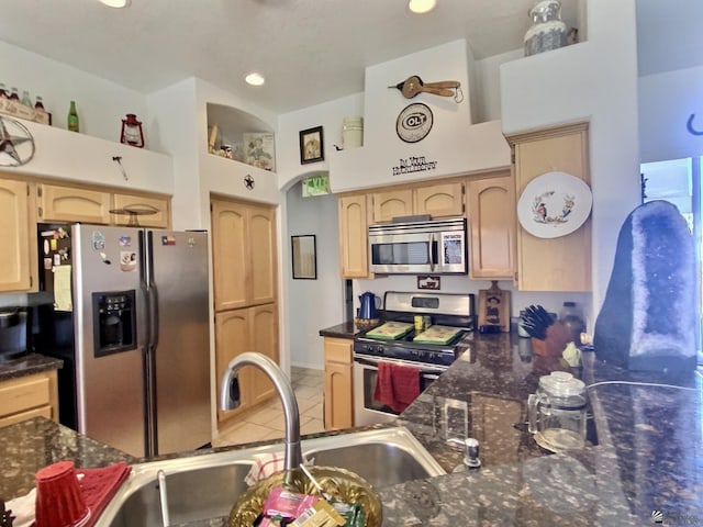 14393 E 53rd Ln, Yuma, AZ 85367 - kitchen featuring light brown cabinetry, light tile patterned flooring, appliances with stainless steel finishes, a sink, and dark stone countertops