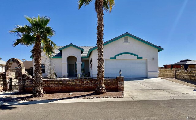 14393 E 53rd Ln, Yuma, AZ 85367 - view of front of property with fence, an attached garage, stucco siding, a tiled roof, and driveway