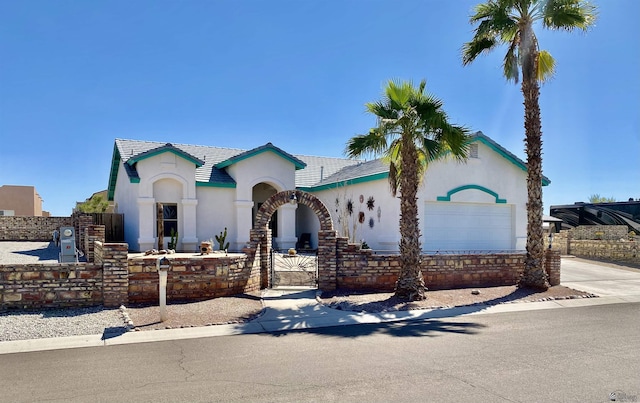 14393 E 53rd Ln, Yuma, AZ 85367 - mediterranean / spanish-style home with a gate, fence private yard, a garage, concrete driveway, and stucco siding