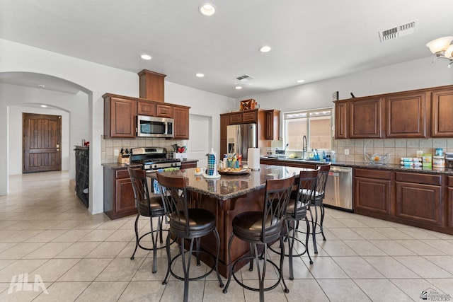 kitchen with stainless steel appliances, visible vents, and light tile patterned floors