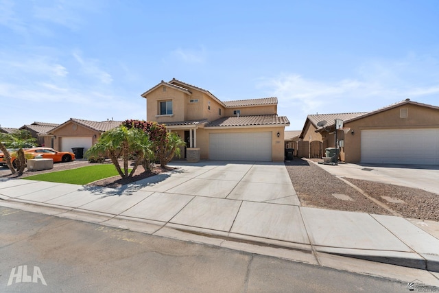 view of front of house featuring fence, a garage, stucco siding, concrete driveway, and a tiled roof