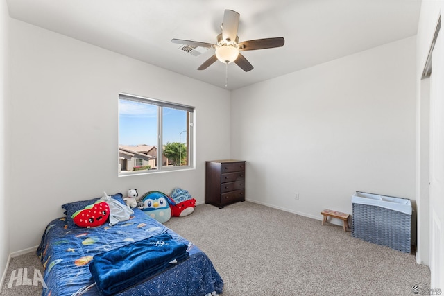 carpeted bedroom featuring baseboards, visible vents, and ceiling fan