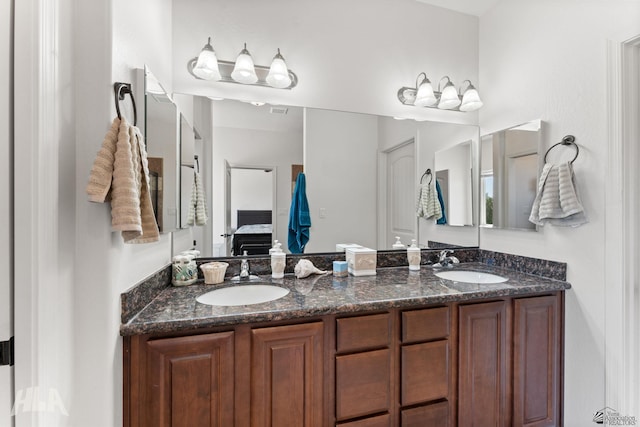ensuite bathroom with a sink, ensuite bathroom, double vanity, and visible vents