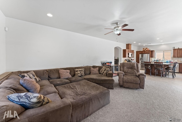 living room with recessed lighting, arched walkways, and a ceiling fan