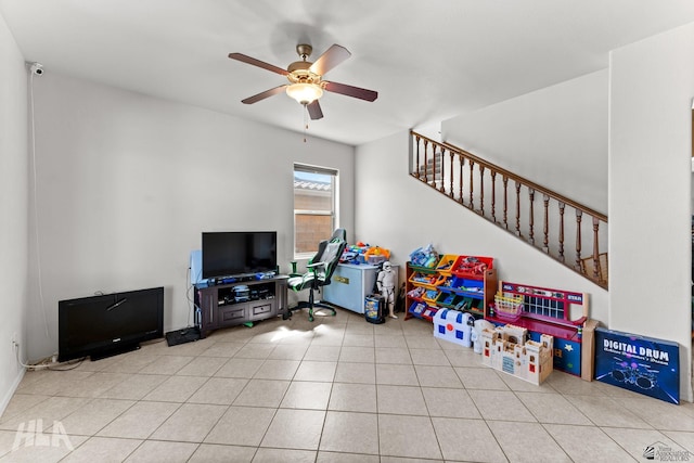 rec room featuring a ceiling fan and light tile patterned floors