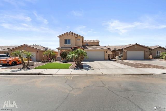 view of front facade featuring an attached garage, stucco siding, a tiled roof, and concrete driveway