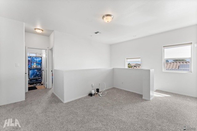 empty room with visible vents, carpet flooring, and baseboards