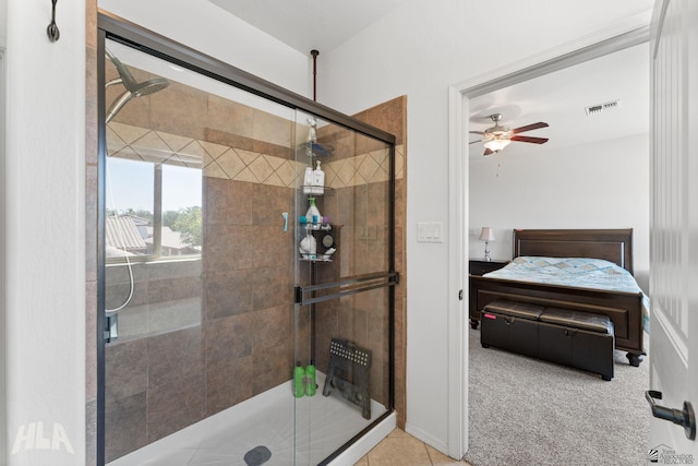 full bathroom with tile patterned floors, ceiling fan, a stall shower, and visible vents