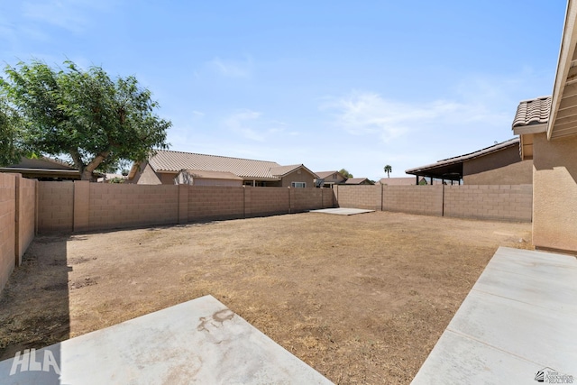 view of yard featuring a fenced backyard and a patio area