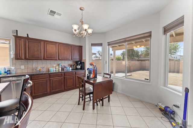 dining space featuring an inviting chandelier, light tile patterned floors, and visible vents