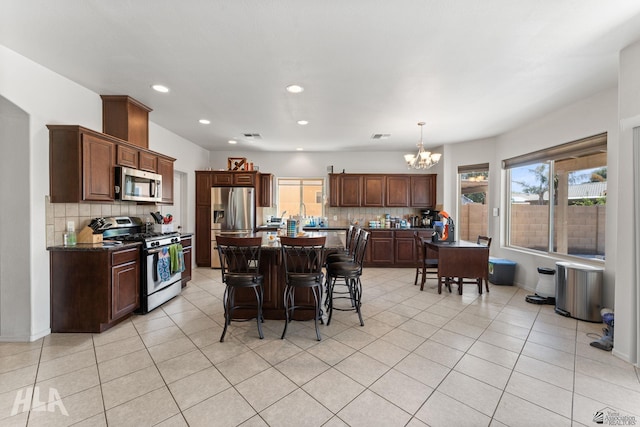 dining room featuring light tile patterned floors, recessed lighting, and a chandelier