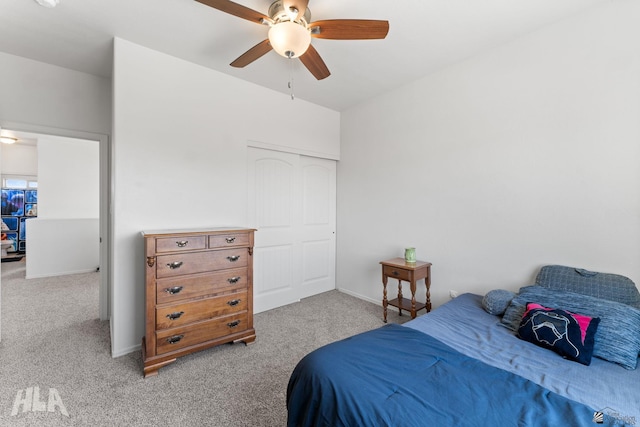 carpeted bedroom featuring baseboards, ceiling fan, and a closet