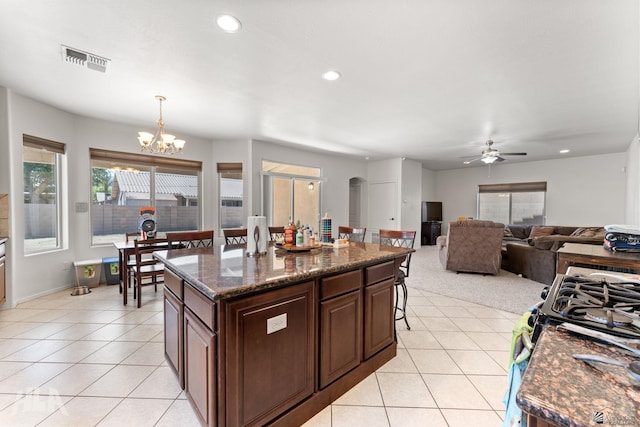 kitchen with recessed lighting, visible vents, light tile patterned floors, and ceiling fan with notable chandelier