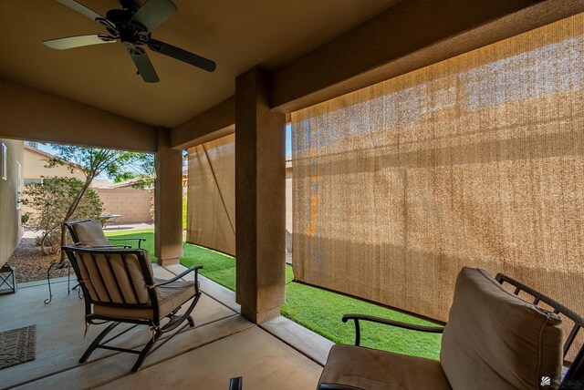 view of patio / terrace with a ceiling fan and fence