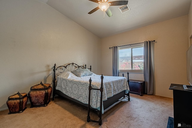 carpeted bedroom featuring a ceiling fan, baseboards, visible vents, and lofted ceiling