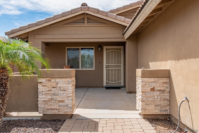 entrance to property featuring stucco siding