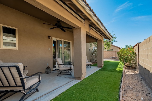 view of patio with a fenced backyard and ceiling fan