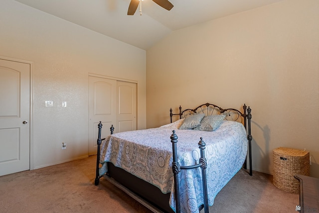 bedroom featuring ceiling fan, baseboards, a closet, lofted ceiling, and carpet flooring