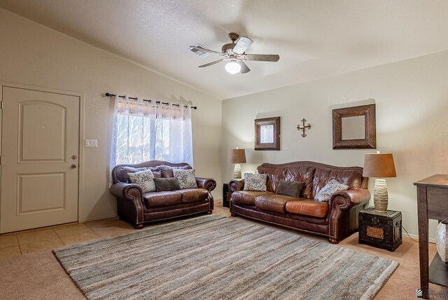 carpeted living area with a ceiling fan, visible vents, and lofted ceiling