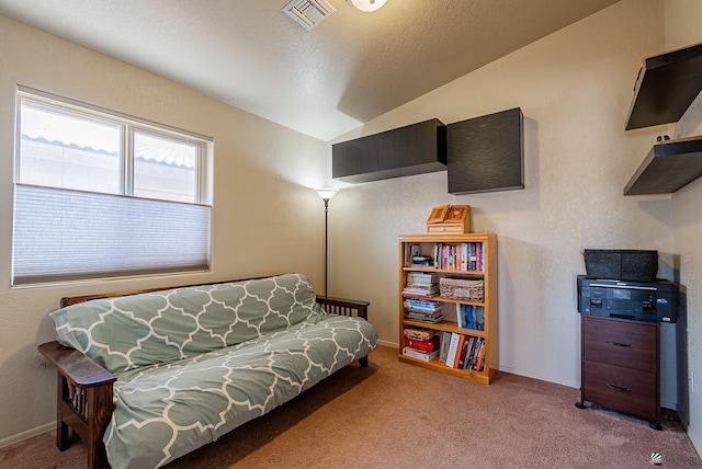 carpeted living room featuring baseboards, visible vents, and lofted ceiling