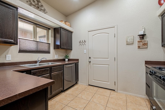 kitchen with dark brown cabinetry, dark countertops, a sink, dishwasher, and gas stove