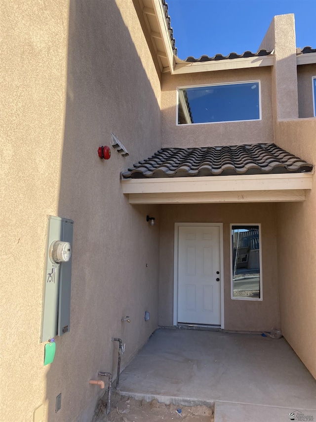 3806 S Sol Dr, Yuma, AZ 85365 - view of exterior entry with a tiled roof and stucco siding