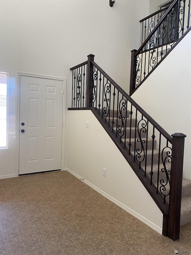 3806 S Sol Dr, Yuma, AZ 85365 - stairway featuring baseboards, tile patterned floors, and a high ceiling