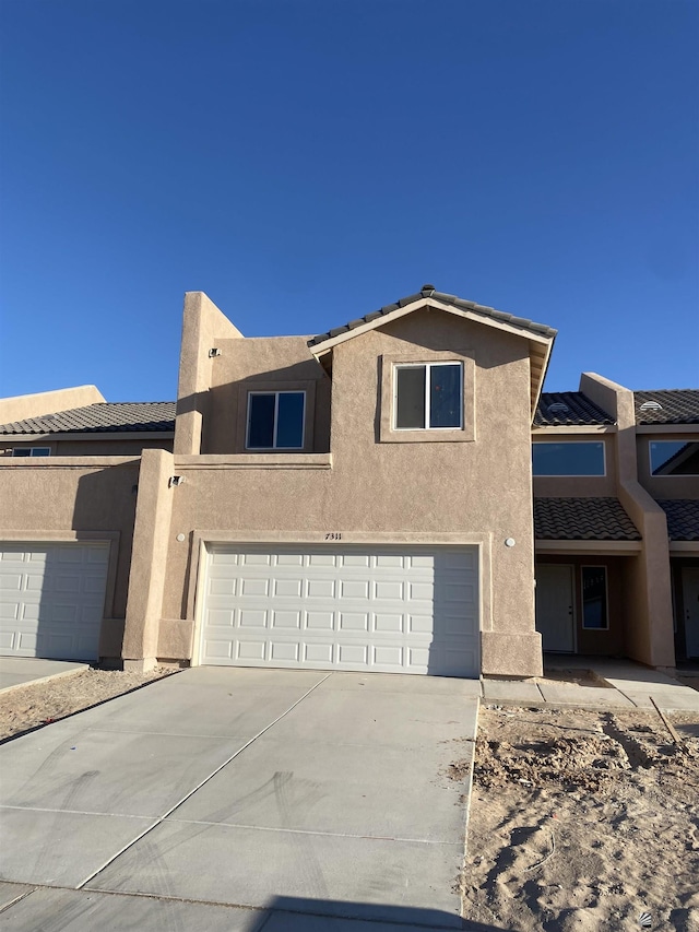 3806 S Sol Dr, Yuma, AZ 85365 - townhome / multi-family property with an attached garage, driveway, a tile roof, and stucco siding