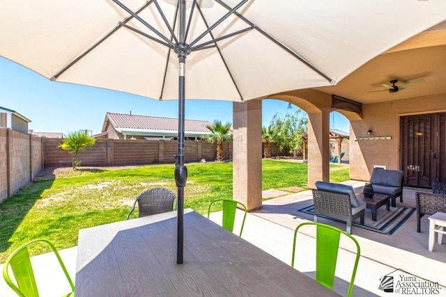 7955 E 37th St, Yuma, AZ 85365 - fenced backyard with a patio, outdoor dining space, and ceiling fan