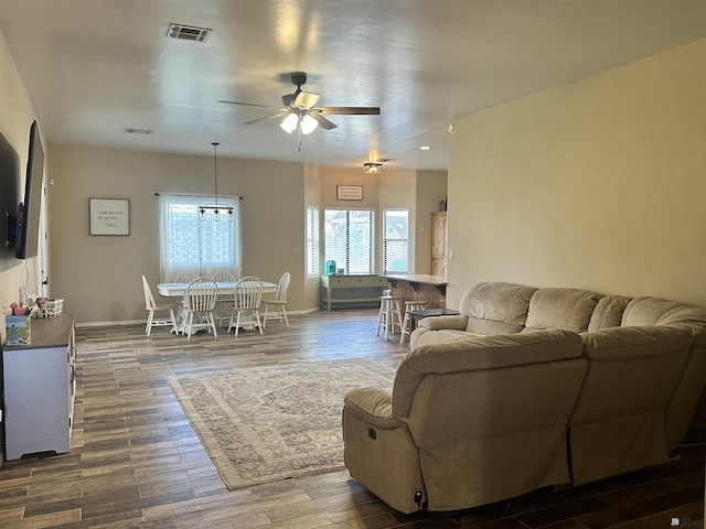 7955 E 37th St, Yuma, AZ 85365 - living room featuring a ceiling fan, dark wood finished floors, and a chandelier