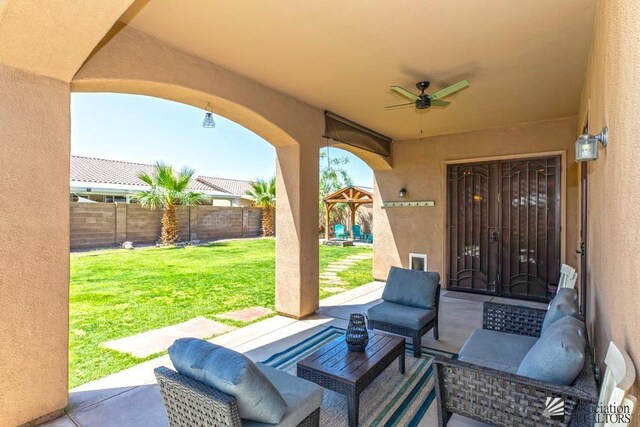 7955 E 37th St, Yuma, AZ 85365 - fenced backyard featuring outdoor lounge area, a ceiling fan, and a patio area