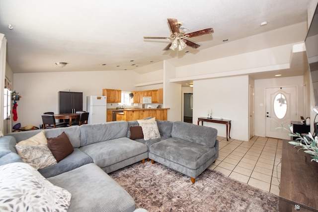 living room featuring light tile patterned flooring, a ceiling fan, vaulted ceiling, and plenty of natural light