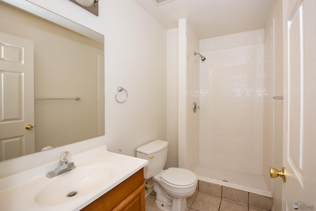 bathroom with visible vents, tile patterned flooring, vanity, toilet, and tiled shower