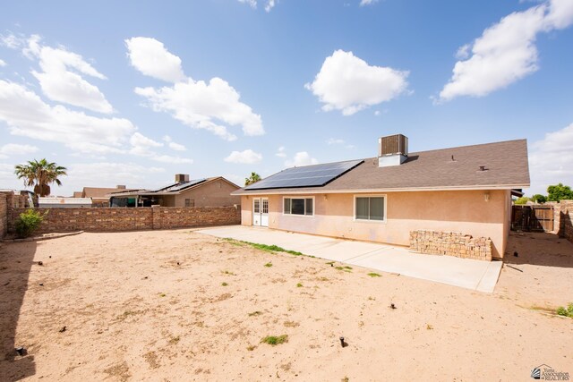 9603 E 36th Pl, Yuma, AZ 85365 - back of house with stucco siding, roof mounted solar panels, a patio, and a fenced backyard