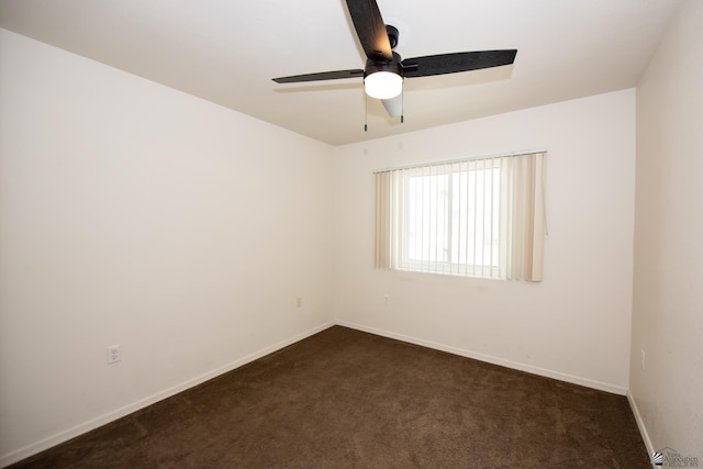 unfurnished room with dark carpet, baseboards, and ceiling fan