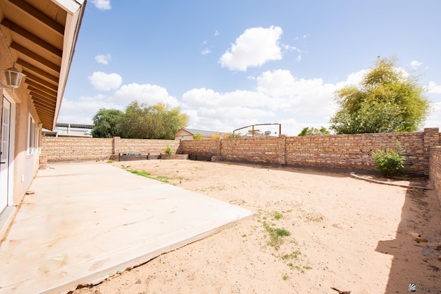 view of yard with a fenced backyard and a patio area