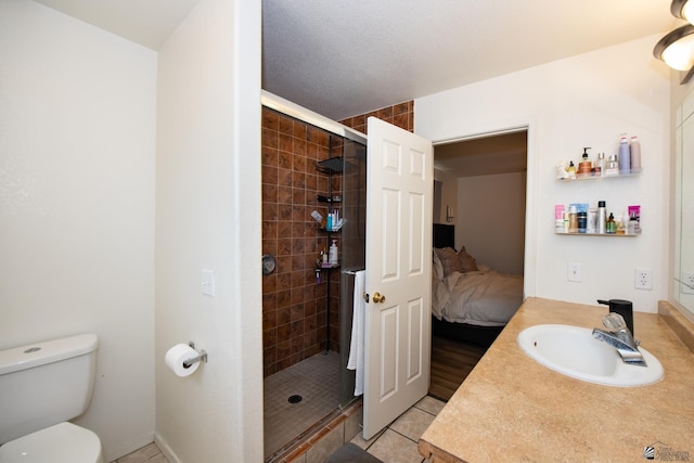 bathroom featuring a shower stall, vanity, tile patterned floors, toilet, and connected bathroom