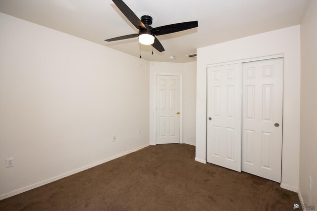 9603 E 36th Pl, Yuma, AZ 85365 - unfurnished bedroom featuring dark colored carpet, a closet, and a ceiling fan