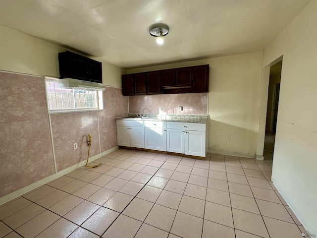 2176 E 14th Pl, Yuma, AZ 85365 - kitchen featuring dark brown cabinets, light countertops, white cabinets, a sink, and light tile patterned floors