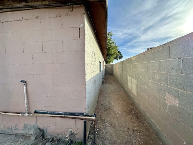 2176 E 14th Pl, Yuma, AZ 85365 - view of side of home with concrete block siding and fence