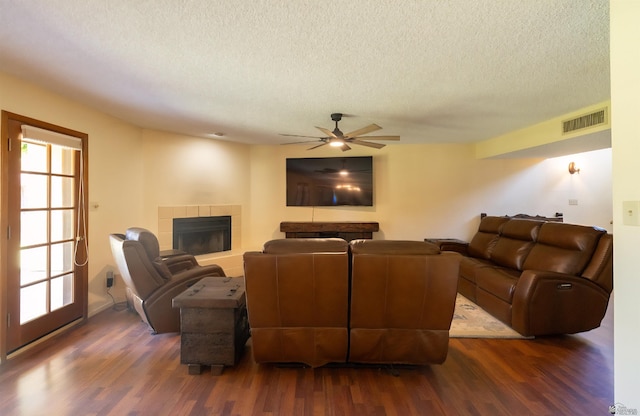 800 E Country Club Dr Unit 26, Yuma, AZ 85365 - living area featuring a textured ceiling, dark wood-style floors, a fireplace, and a ceiling fan
