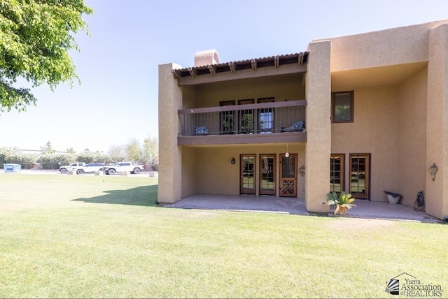800 E Country Club Dr Unit 26, Yuma, AZ 85365 - back of property featuring french doors, stucco siding, a yard, and a balcony