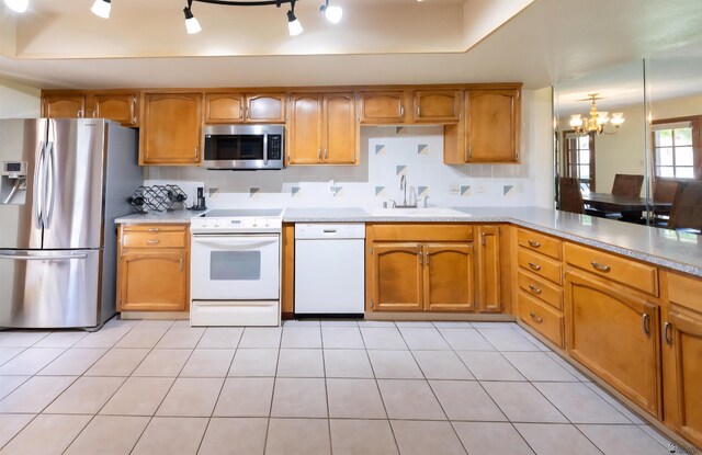 800 E Country Club Dr Unit 26, Yuma, AZ 85365 - kitchen featuring appliances with stainless steel finishes, a sink, a chandelier, and light countertops