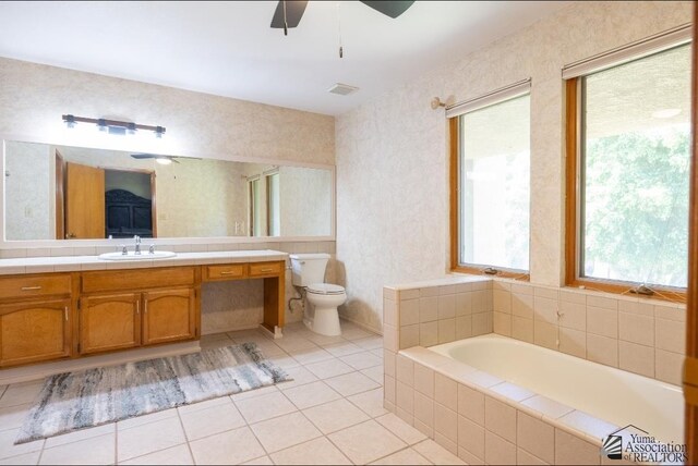 800 E Country Club Dr Unit 26, Yuma, AZ 85365 - bathroom with a garden tub, vanity, a ceiling fan, toilet, and tile patterned floors